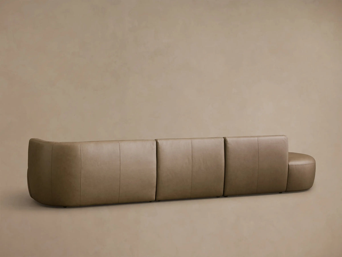 Close-up of the tan leather on the Lovina Leather Three-Piece Bumper Sectional, showing detailed stitching.