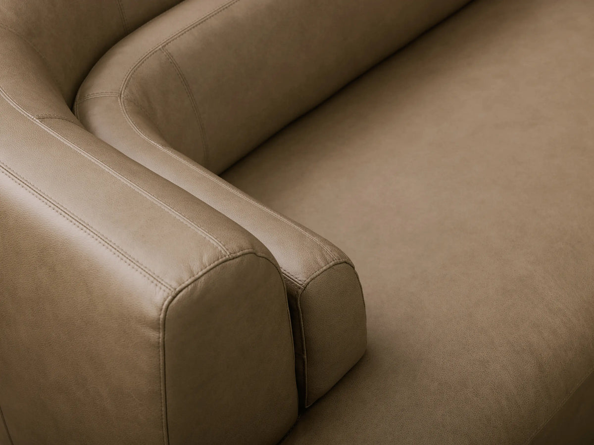 Front view of an olive-brown Lovina Leather Three-Piece Bumper Sectional featuring a curved right bumper chaise.