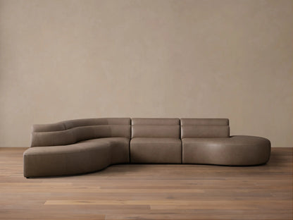 Front view of the taupe Lovina Leather Four-Piece Bumper Sectional, showcasing its sweeping modular curve.