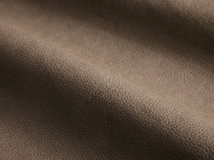 Close-up of the taupe leather on the Lovina Leather Four-Piece Bumper Sectional.