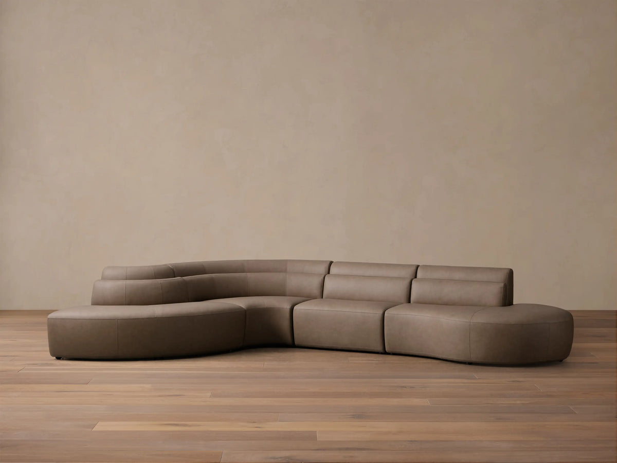 Front view of a taupe Lovina Leather Four-Piece Bumper Sectional, featuring a curved, modular design.