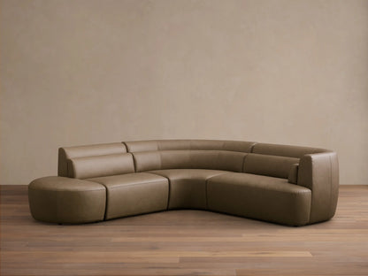 Rear view of the taupe Lovina Leather Four-Piece Sectional with Ottoman, showcasing its curved, segmented design.