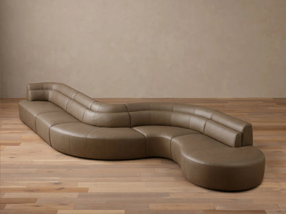 Front view of the light brown Lovina Leather Five-Piece Sectional, showcasing its curved, organic shape.