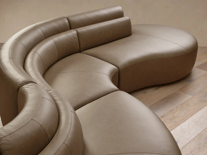 Full view of the taupe Lovina Leather Five-Piece Sectional with a curved, serpentine design and segmented backrests.