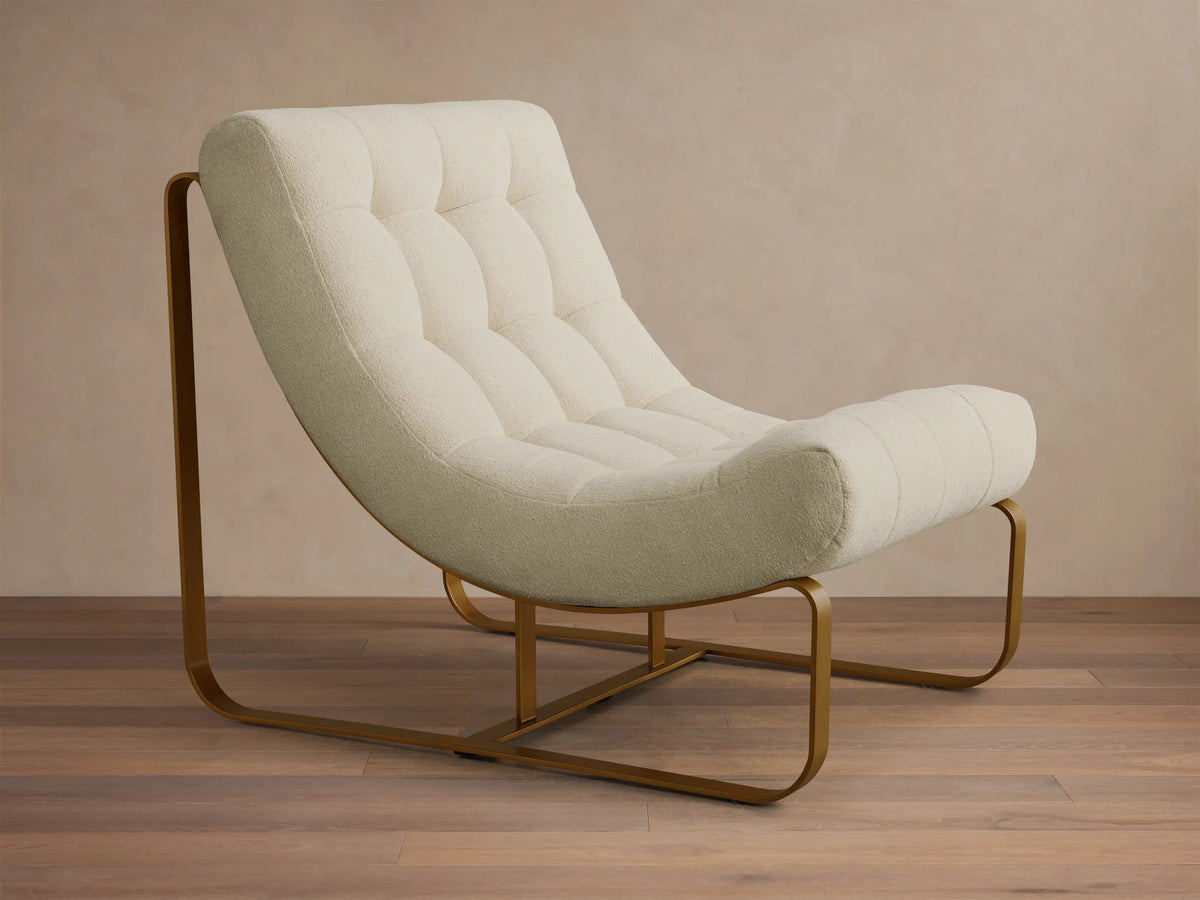 Front view of a cream boucle Callaway Chair with tufted cushions and a curved gold-toned metal frame.