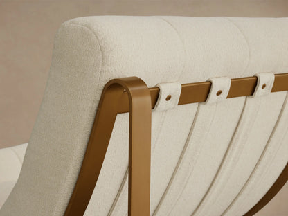Angled back view of the cream textured Callaway Chair with a tufted seat and gold metal frame supporting vertical fabric straps.