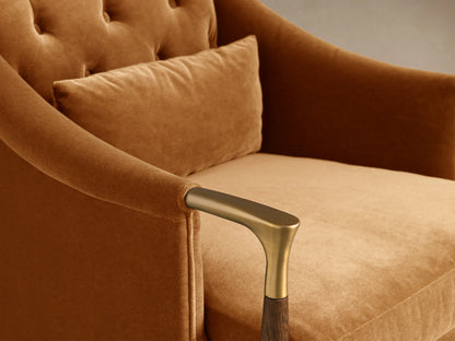Side/Rear view of a Caramel Fisher Club Chair with plush upholstery, dark wooden tapered legs with brass caps, and a wooden armrest detail.