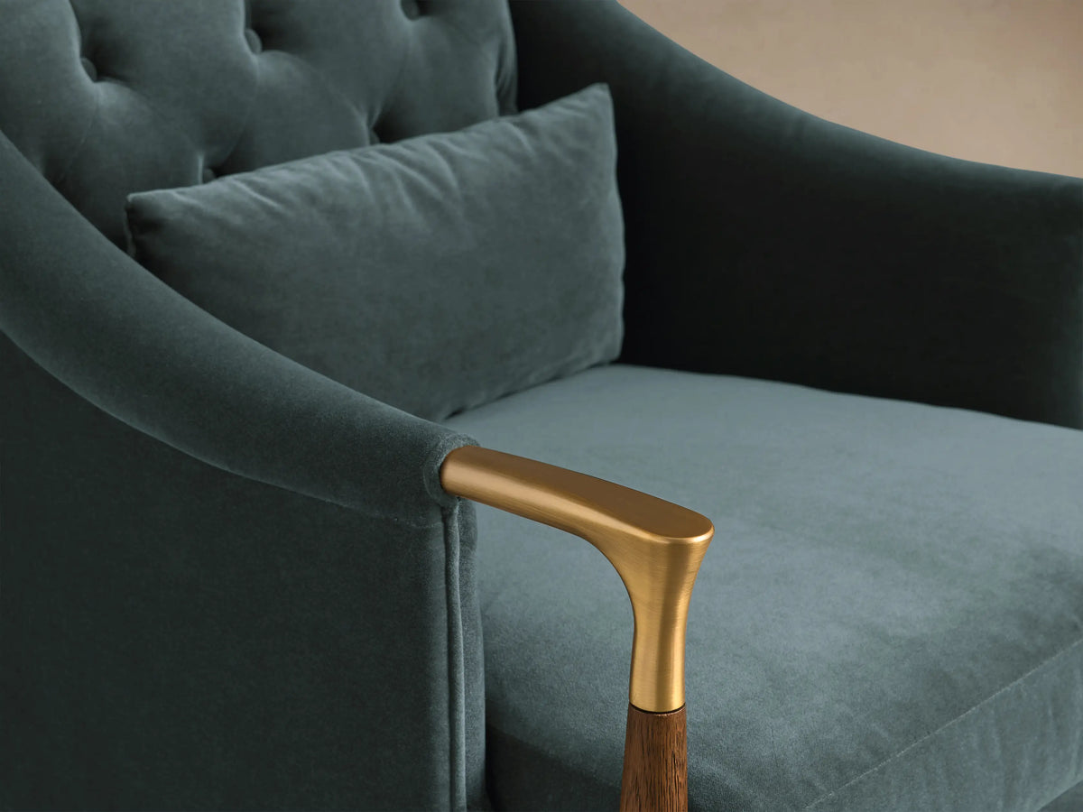 Front view of the teal Fisher Club Chair with a tufted back, matching lumbar pillow, and wooden legs with brass accents.