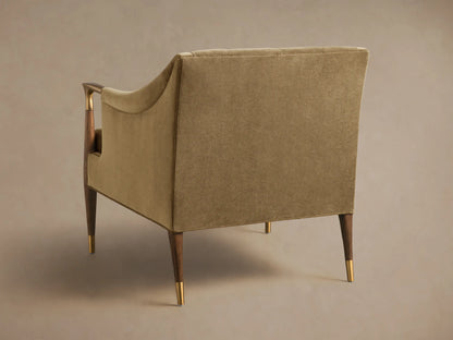 Rear-side view of a moss green Fisher Club Chair, featuring dark wood legs with brass caps and wood and brass arm details.