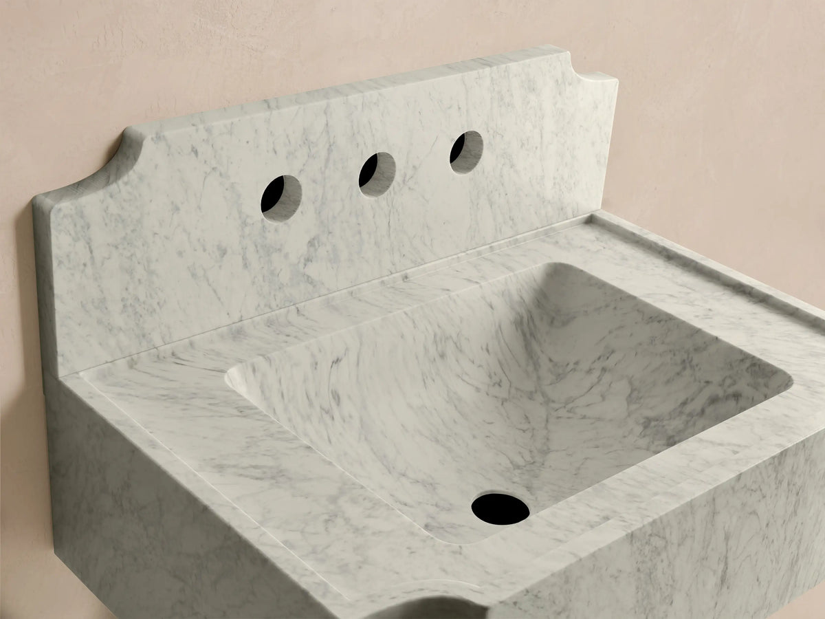 Front view of the white marble Dottie Wall-Mounted Sink with Backsplash, featuring three faucet holes and an integrated backsplash.