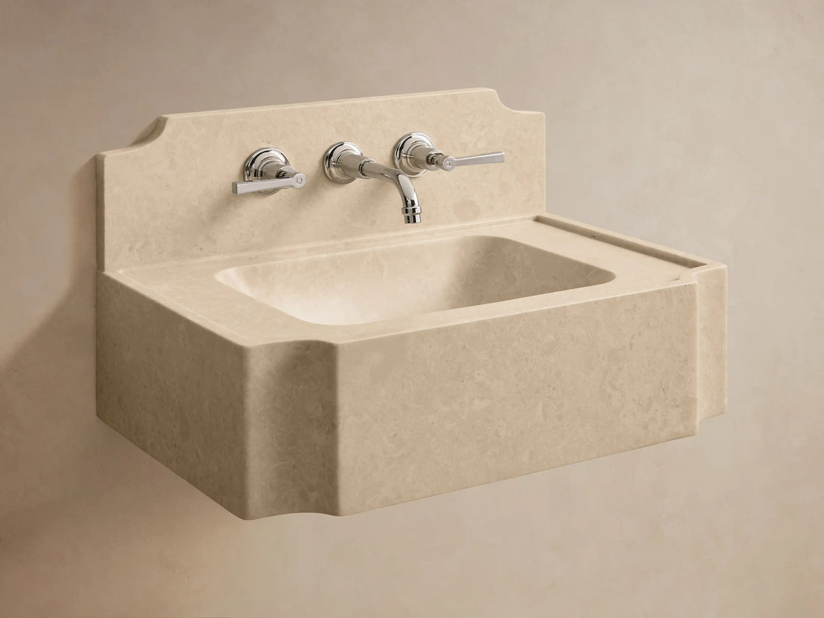 Front view of the light beige Dottie Wall-Mounted Sink with Backsplash, a solid stone sink with three black faucet holes and a curved top.