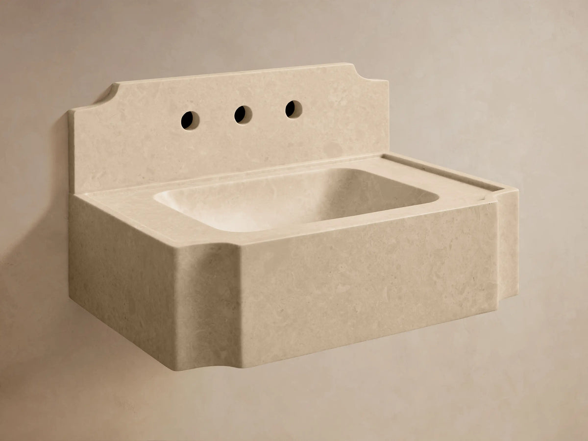 Front view of the light beige stone Dottie Wall-Mounted Sink with Backsplash and chrome faucet fixtures.