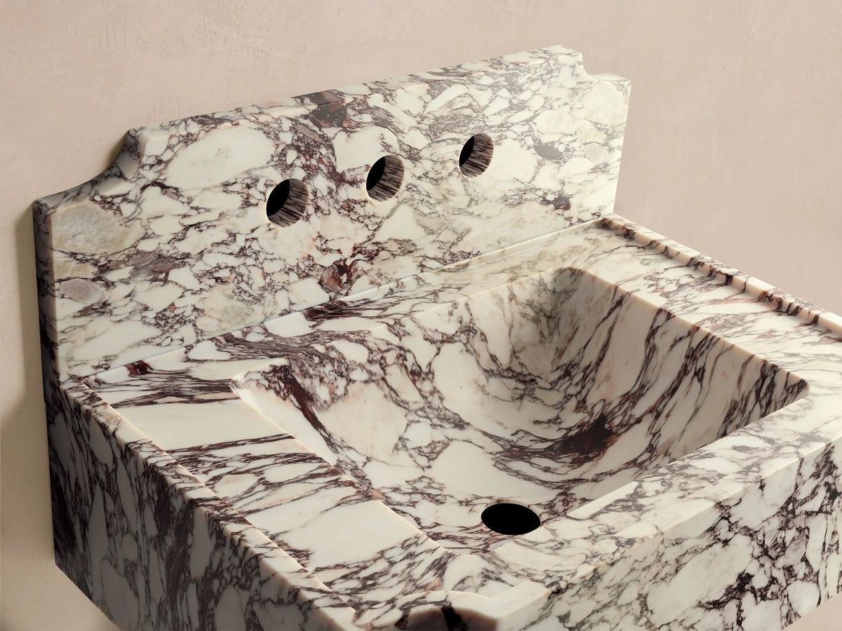 Front view of the white and maroon marbled Dottie Wall-Mounted Sink with Backsplash, featuring three faucet holes and a scalloped edge.