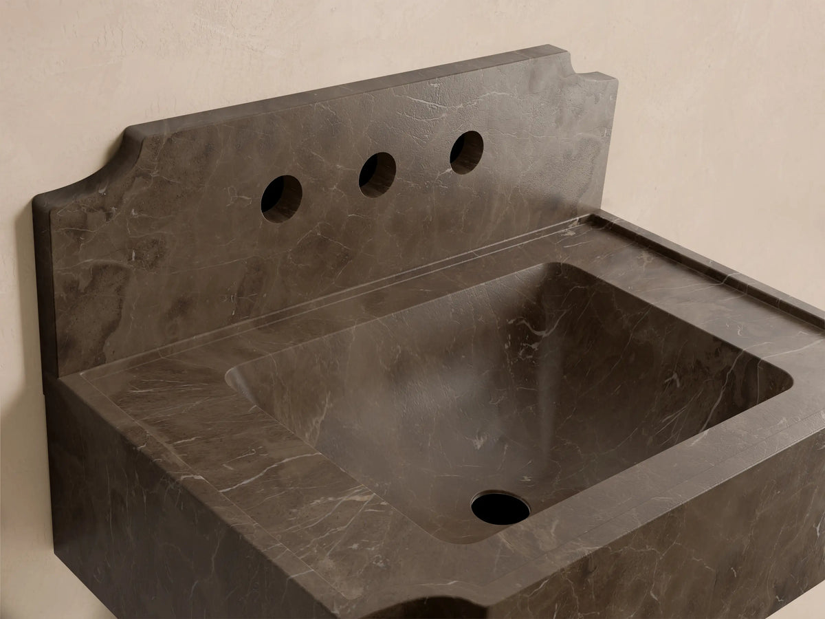 Front view of the dark gray mottled stone Dottie Wall-Mounted Sink with Backsplash, featuring three faucet holes.