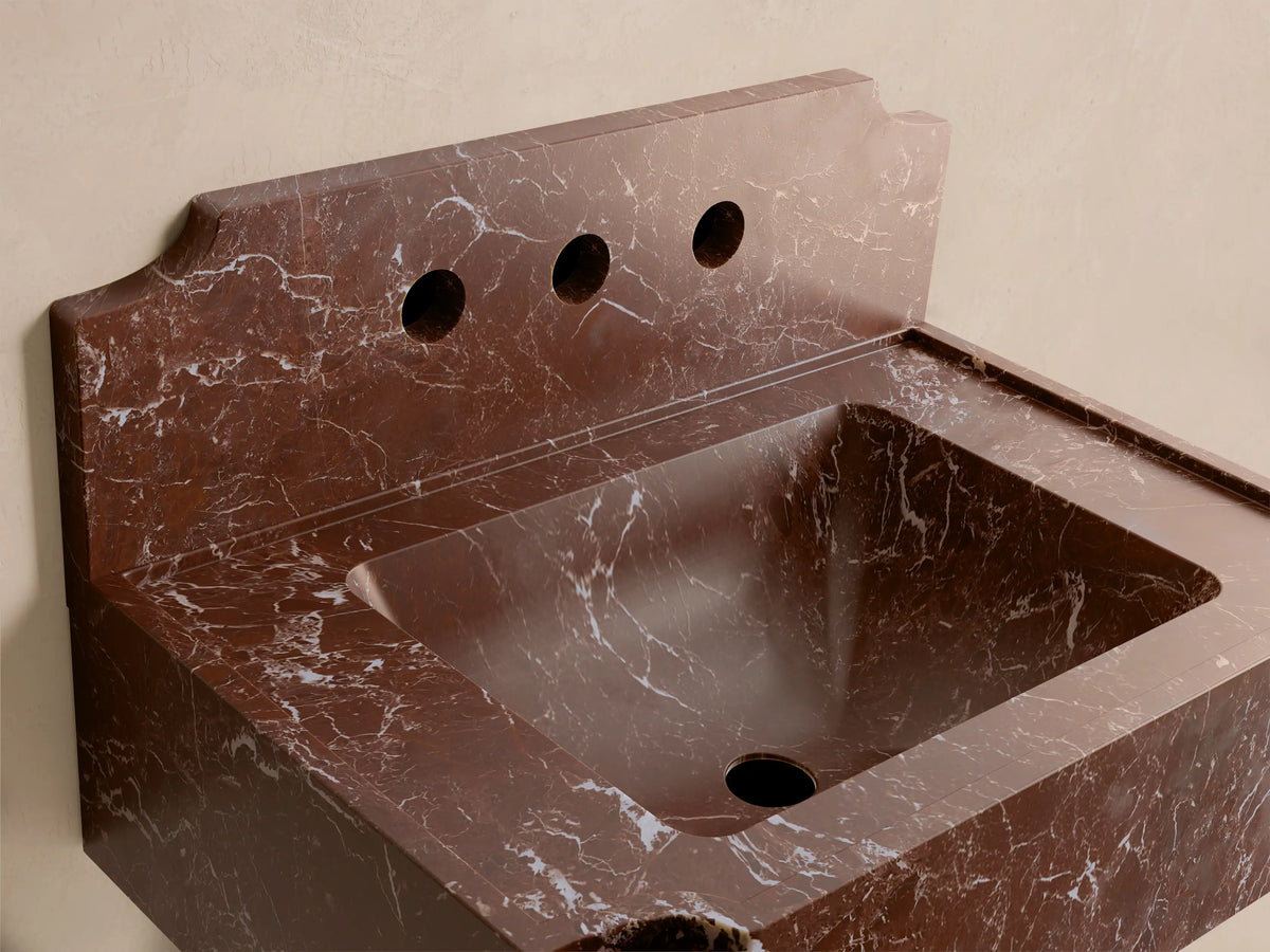 Front view of the reddish-brown Dottie Wall-Mounted Sink with Backsplash, featuring white veining and three faucet holes.