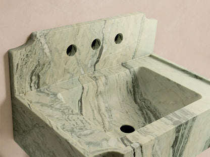 Front-right view of the light green and white marbled Dottie Wall-Mounted Sink with Backsplash, with dark grey veining and three faucet holes.