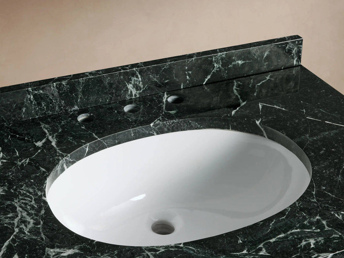 Front 3/4 view of a dark green Oakleigh Single Vanity with a black and white veined marble top, oval sink, and gold handles.