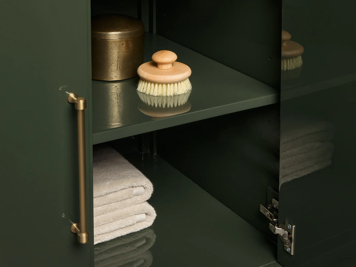 Close-up of Oakleigh Single Vanity: dark green veined marble top, white oval sink, three faucet holes.