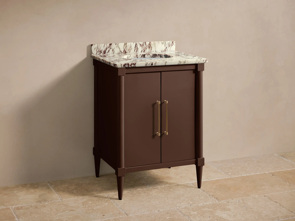 Front view of the dark brown Oakleigh Powder Vanity™ with a white veined marble top, gold faucet, and two brass handles.