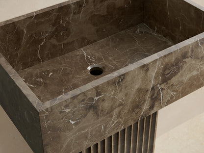 Front view of the dark brown marbled Riven Pedestal Sink, featuring a fluted base and seamlessly integrated top.