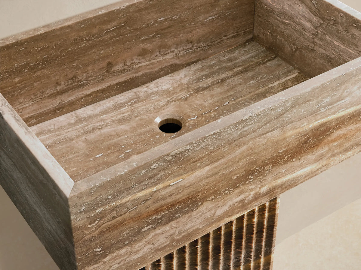 Front view of the natural brown stone Riven Pedestal Sink, featuring a rectangular basin and a fluted pedestal base.