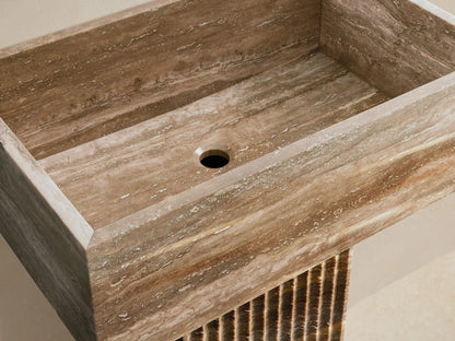 Front view of the natural brown stone Riven Pedestal Sink, featuring a rectangular basin and a fluted pedestal base.