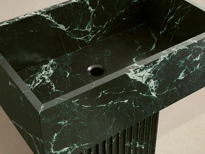 Front view of the dark green Riven Pedestal Sink with white marbling, featuring a rectangular basin and fluted base.