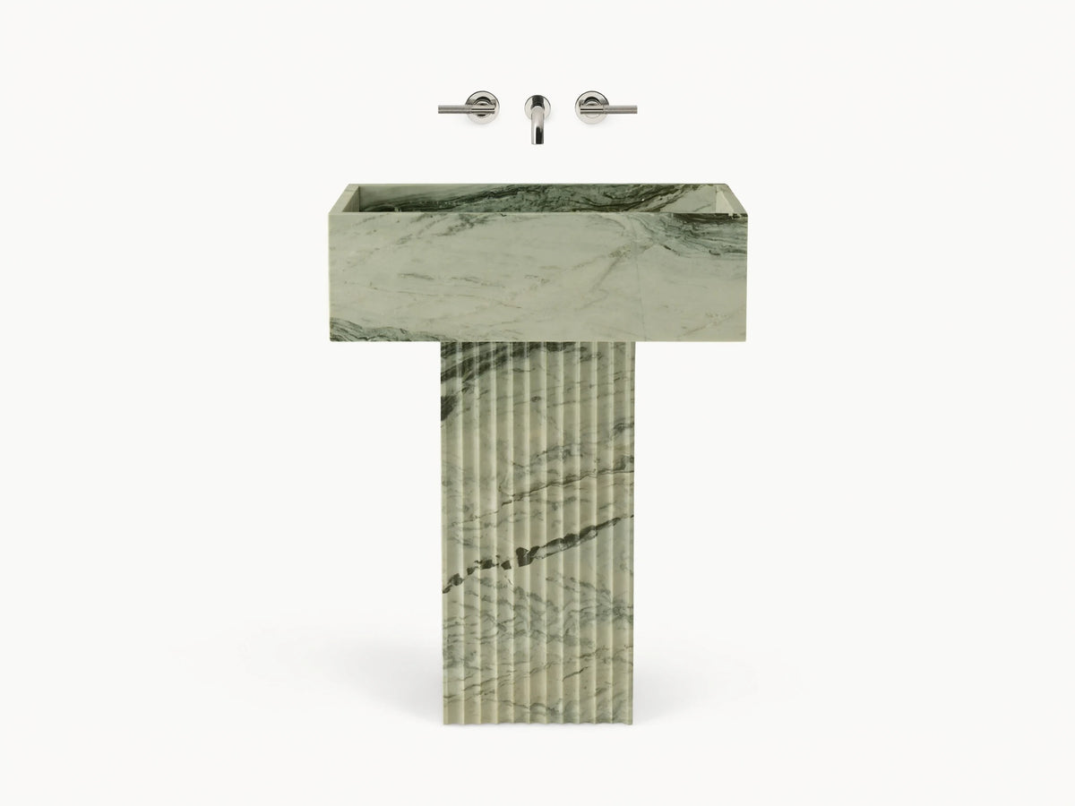 Front view of green marbled Riven Pedestal Sink, showcasing fluted base and natural black veining.