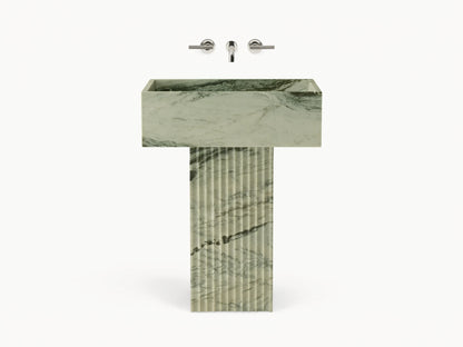Front view of green marbled Riven Pedestal Sink, showcasing fluted base and natural black veining.