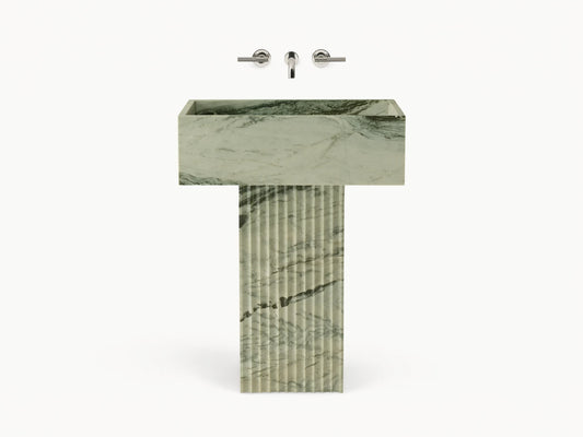 Front view of green marbled Riven Pedestal Sink, showcasing fluted base and natural black veining.