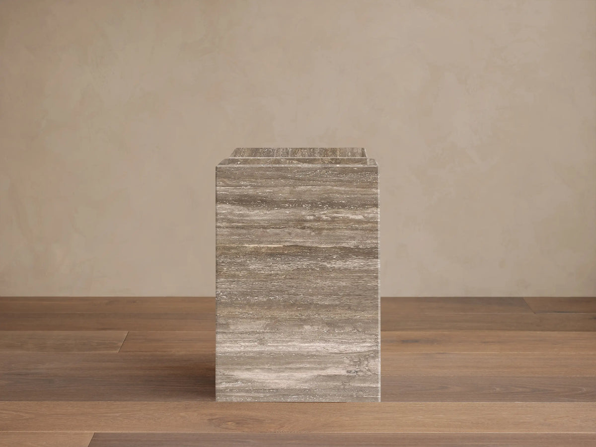 Front view of the Marmont Pedestal, a rectangular stone pedestal with horizontal veining in shades of gray, brown, and beige.