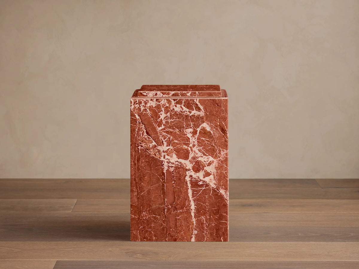 Front view of a reddish-brown natural stone Marmont Pedestal with white veining, matte finish, and stepped top.