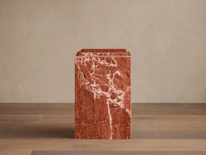Front view of a reddish-brown natural stone Marmont Pedestal with white veining, matte finish, and stepped top.