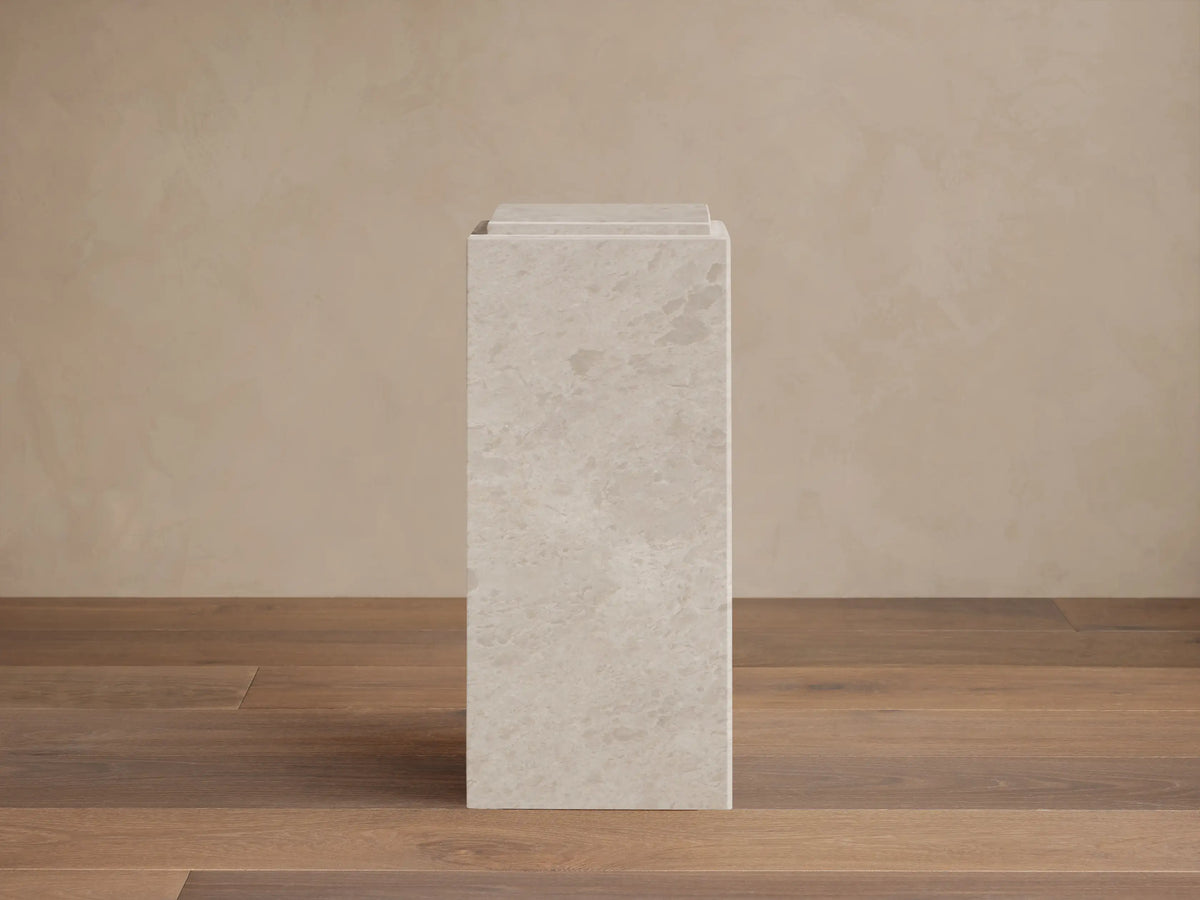Front view of the light grey natural stone Marmont Pedestal, featuring subtle veining.