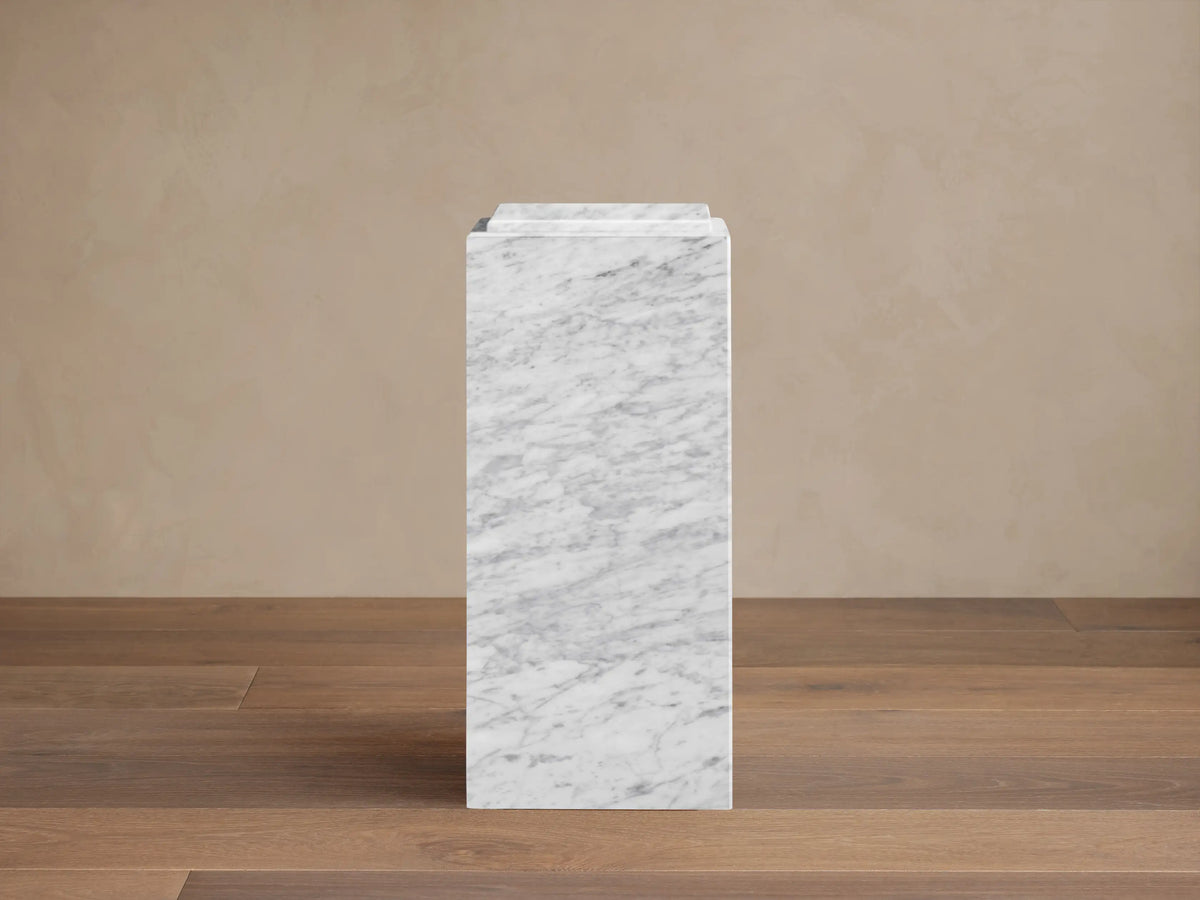Front view of the white and gray marble Marmont Pedestal, rectangular with a stepped top design.