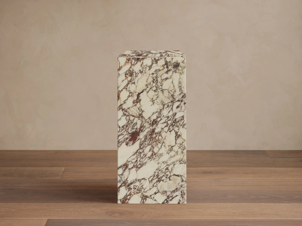 Front view of white natural stone Marmont Pedestal with reddish-brown veining and matte finish.
