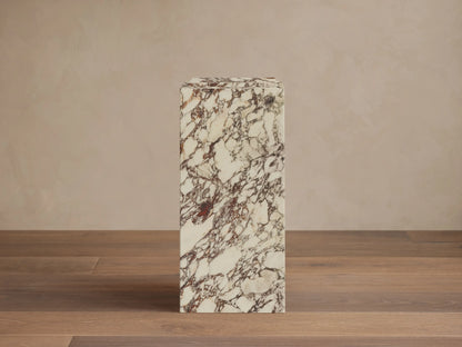 Front view of white natural stone Marmont Pedestal with reddish-brown veining and matte finish.