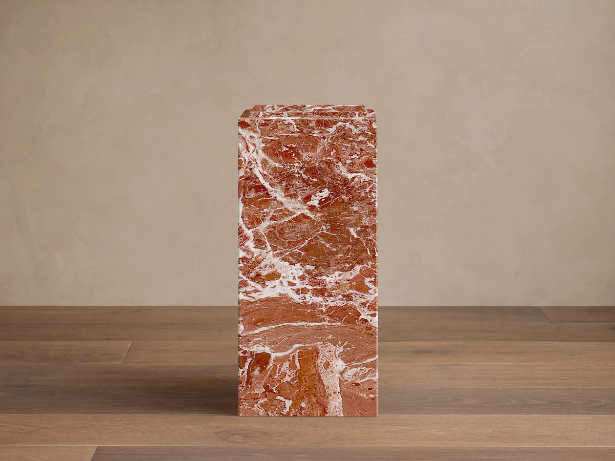 Front view of a reddish-brown Marmont Pedestal with prominent white marble veining.
