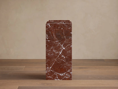 Front view of the red marble Marmont Pedestal, a rectangular column with a tiered top and natural white veining.