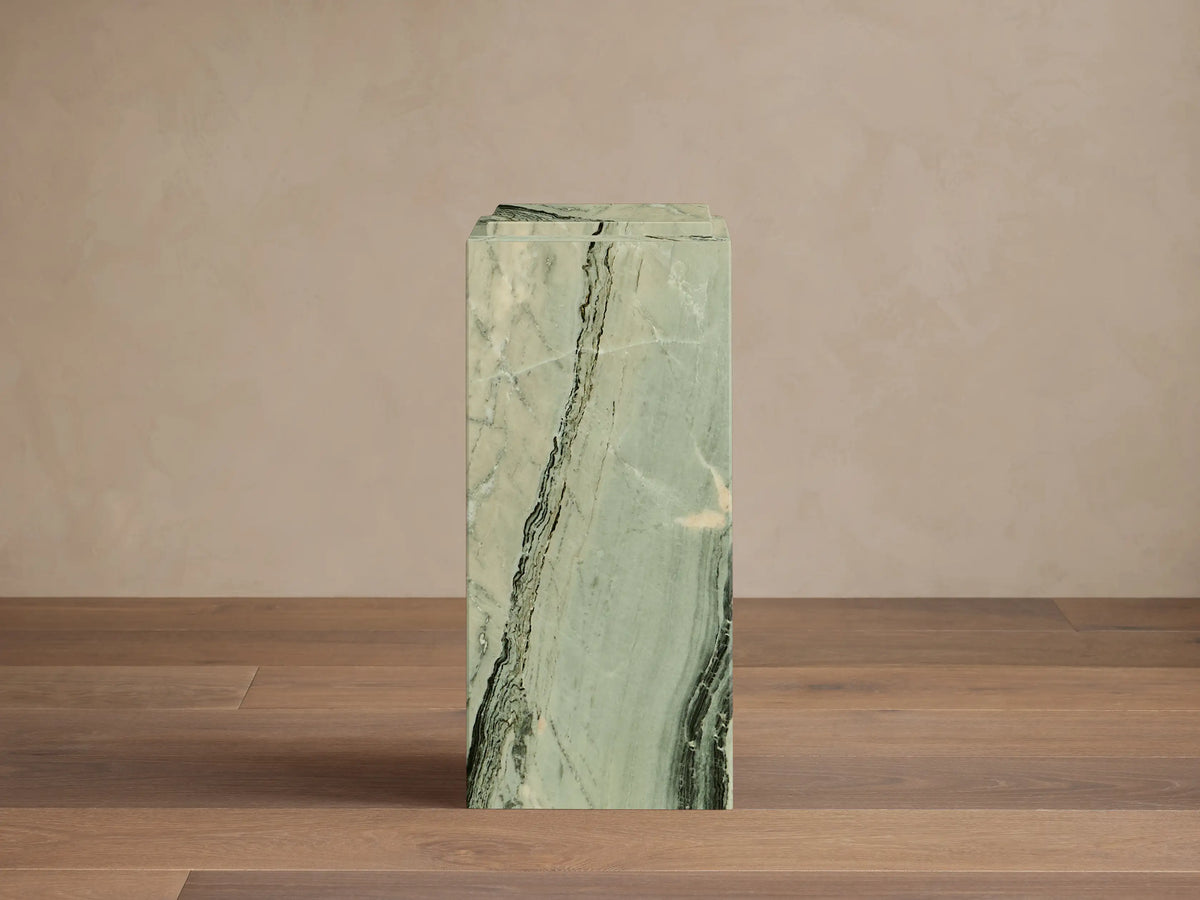Front view of the green Marmont Pedestal, a tall rectangular column with natural dark green and white marble veining.