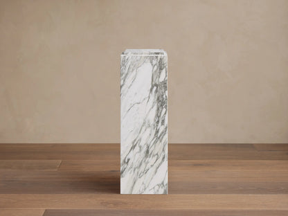 Front view of the white Marmont Pedestal, a tall square natural stone column with distinctive gray veining.