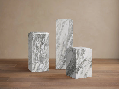 Front view of the white natural stone Marmont Pedestal with grey veining and a matte lacquer finish.