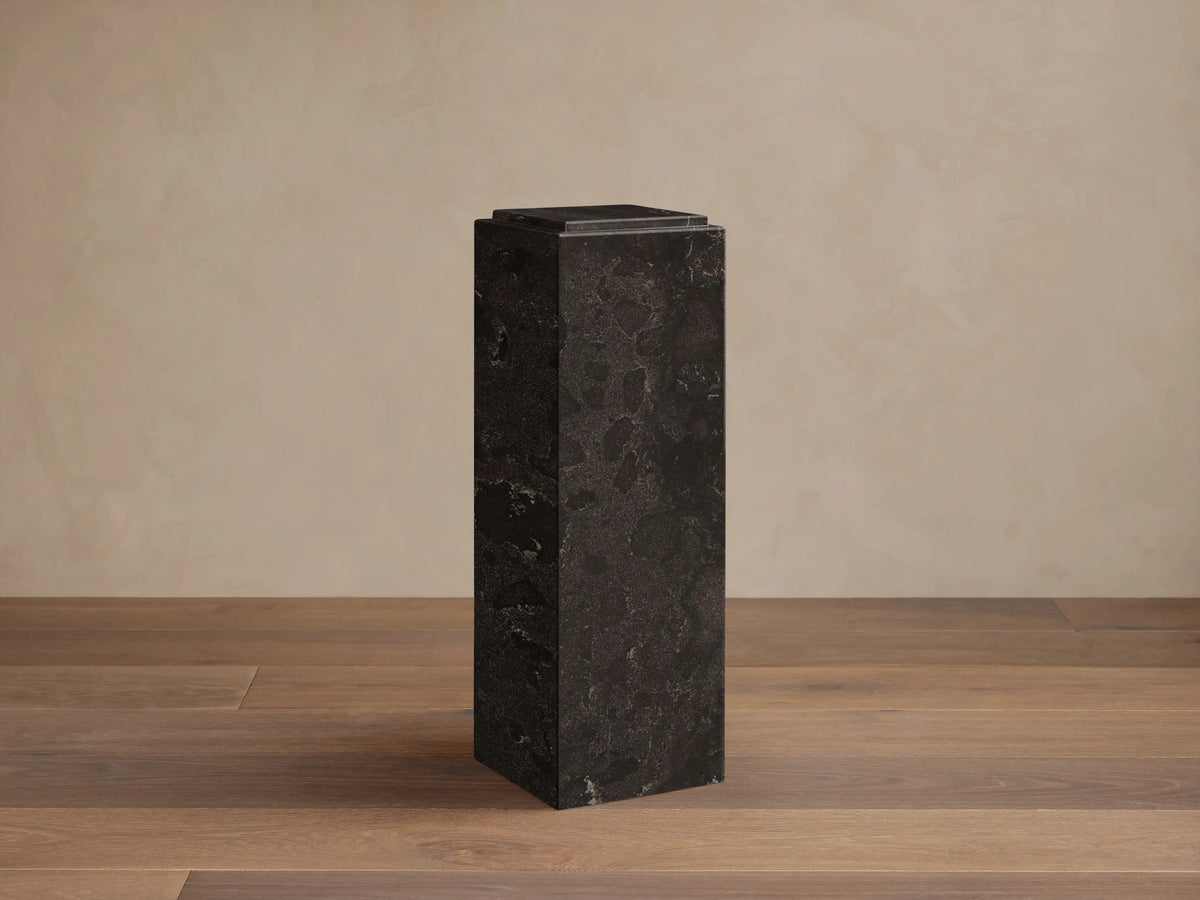 Front view of the dark, rectangular Marmont Pedestal with natural stone veining and a matte finish.