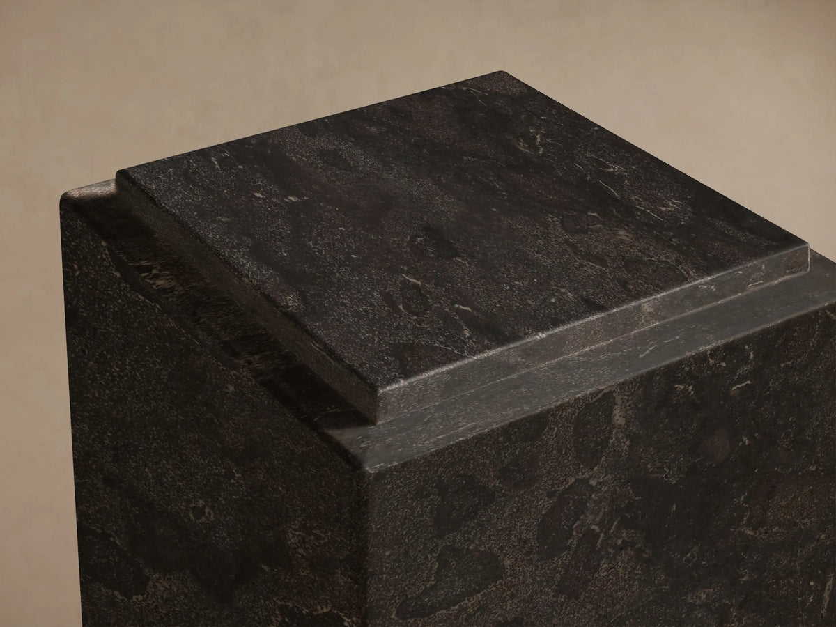 Front view of the dark Marmont Pedestal, a tall, square natural stone pillar with visible lighter veining and a matte finish.