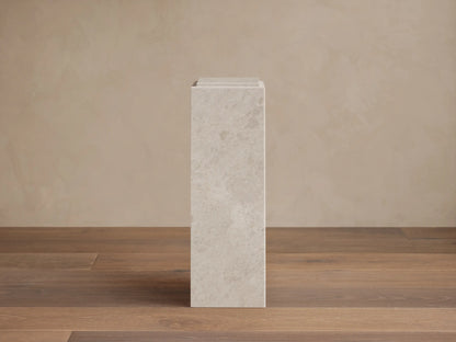 Front view of a rectangular light gray natural stone Marmont Pedestal with subtle veining and a matte finish.
