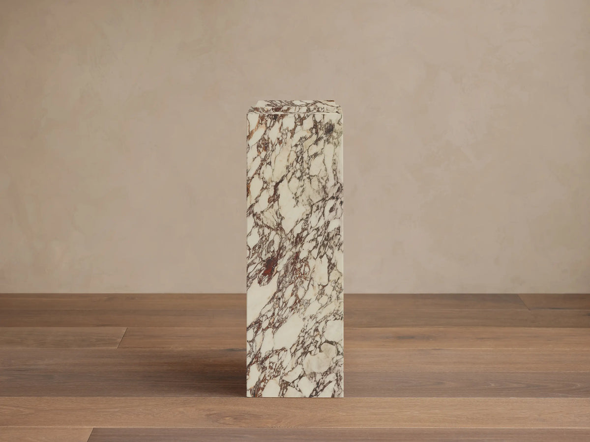 Front-right view of the white stone with reddish-brown veining Marmont Pedestal.