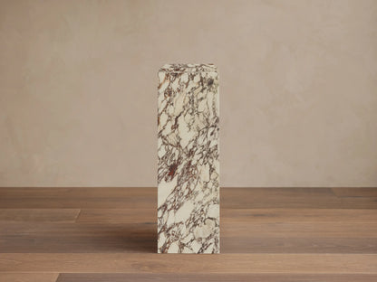 Front-right view of the white stone with reddish-brown veining Marmont Pedestal.