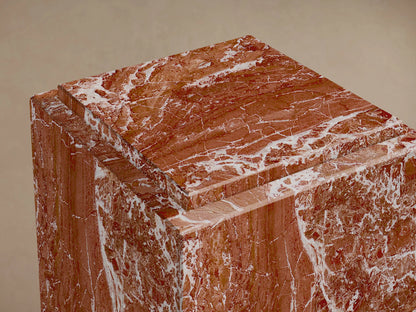 Close-up of the red veined natural stone Marmont Pedestal, showing the stepped top design.