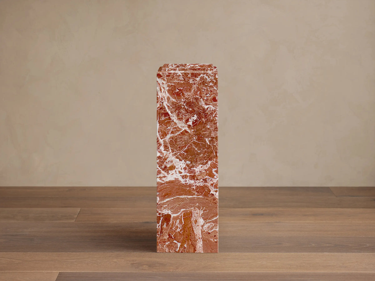 Front view of three rectangular reddish-brown marble Marmont Pedestals with white veining, in varying heights, one with a stepped top.