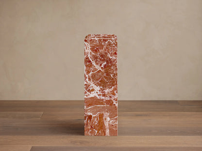 Front view of three rectangular reddish-brown marble Marmont Pedestals with white veining, in varying heights, one with a stepped top.